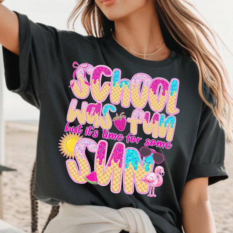 May include: Black t-shirt with a pink, blue, and yellow graphic that says "School was fun but it's time for some sun". The graphic is designed to look like an ice cream cone with sprinkles and a strawberry.
