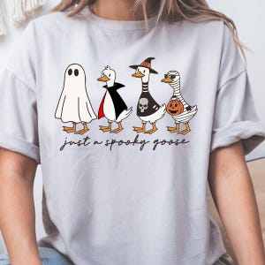 a woman wearing a t - shirt that says just a spooky place