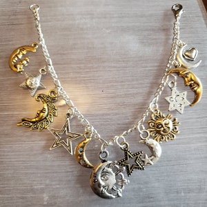 Moon Stars and Sun Bracelet Handmade Victorian Vintage Recycle Fashion and Costume jewelry with 12 different charms.  Free shipping eligible