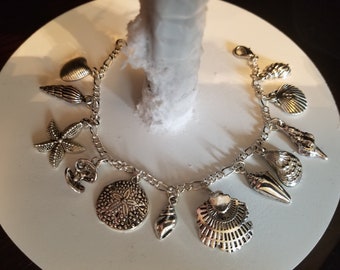 Seashells bracelet Handmade vintage Victorian recycled fashion and costume jewelry with 12 different charms.  Free shipping eligible.