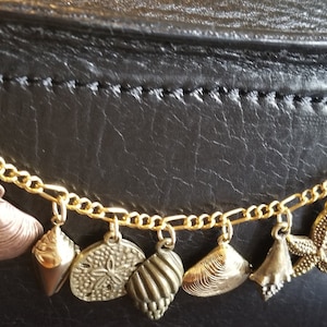 Seashell bracelet handmade Victorian, vintage, recycled, costume and fashion jewelry bracelet  from the ocean in gold w/12 charms.