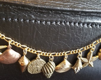 Seashell bracelet handmade Victorian, vintage, recycled, costume and fashion jewelry bracelet  from the ocean in gold w/12 charms.