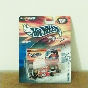 May include: A Hot Wheels Racing die-cast toy car in a blister pack. The car is red, white, and black with the number 16 and the word "Grainger" on the side. The car is a replica of Greg Biffle's NASCAR race car.