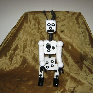 Black and White Robot With Movable Arms