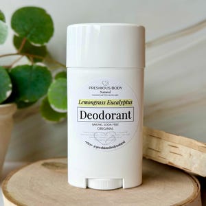 White deodorant stick with a label that reads 'Preshious Body Natural Handcrafted Skincare Lemongrass Eucalyptus Deodorant Baking Soda Free Original *etsy @preshiousbodynatural'.