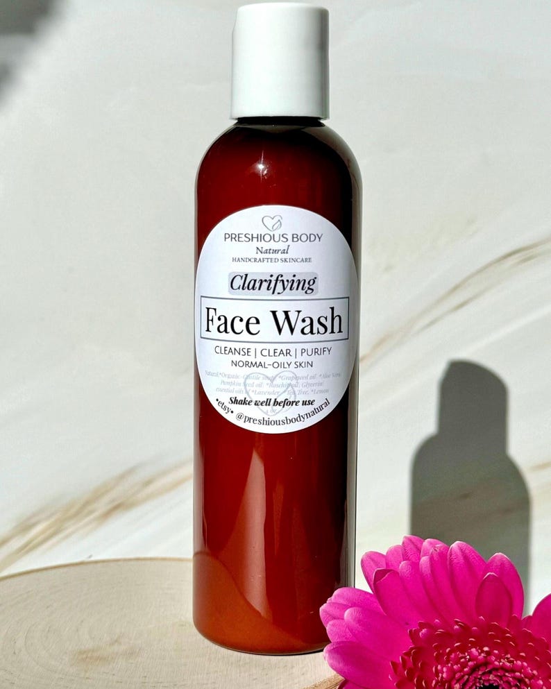 A brown bottle of clarifying face wash with a white label that reads 'Preshious Body Natural Handcrafted Skincare Clarifying Face Wash Cleanse | Clear | Purify Normal-Oily Skin Shake well before use etsy @preshiousbodynatural'.
