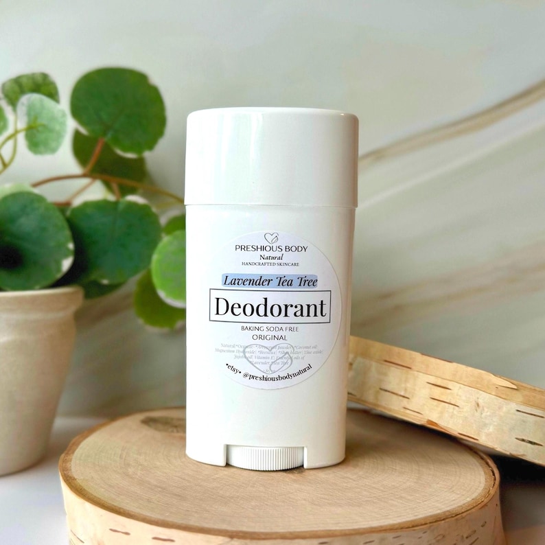 A white deodorant stick with the words 'Original' and 'Baking Soda Free' printed on the label. The deodorant is on a white wooden surface.