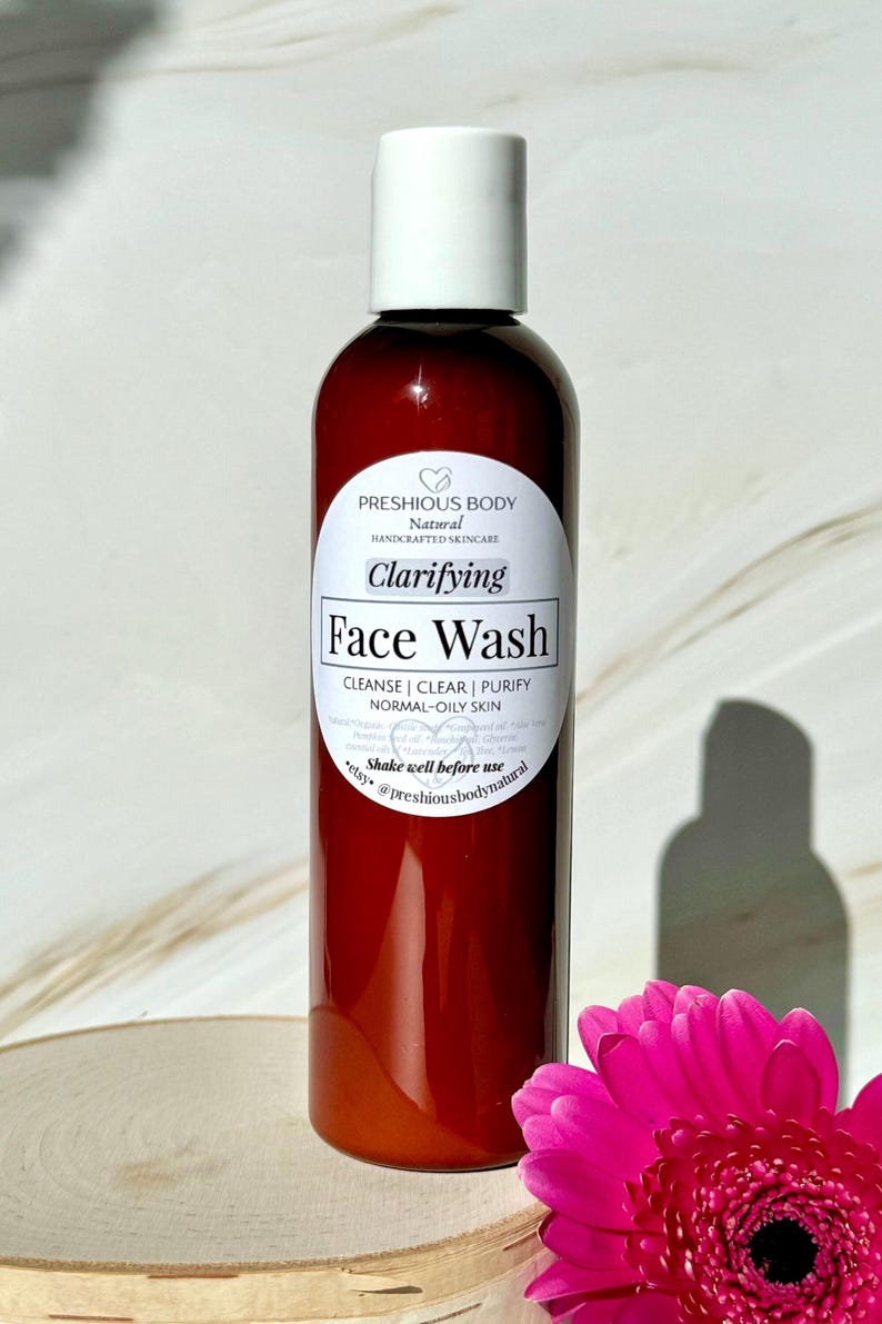 A brown bottle of clarifying face wash with a white label that reads 'Preshious Body Natural Handcrafted Skincare Clarifying Face Wash Cleanse | Clear | Purify Normal-Oily Skin Shake well before use etsy @preshiousbodynatural'.