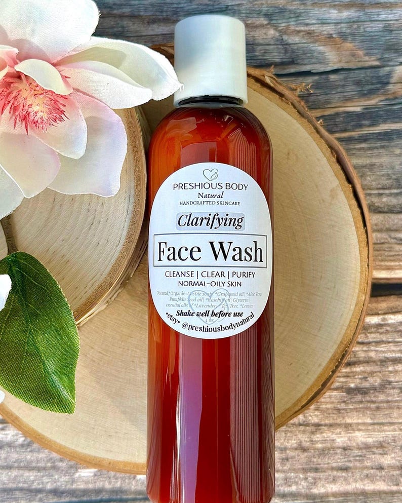 A brown bottle of clarifying face wash with a white label that reads 'Preshious Body Natural Handcrafted Skincare Clarifying Face Wash Cleanse | Clear | Purify Normal-Oily Skin Shake well before use etsy @preshiousbodynatural'.