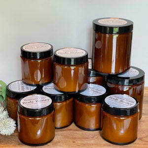 Multiple glass jars of body butter shown to reflect the size options