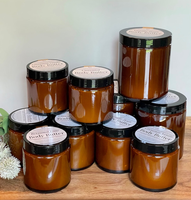 Multiple glass jars of body butter shown to reflect the size options