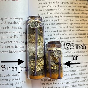 May include: Two glass jars filled with various herbs, crystals, and dried flowers. The jars are labeled with the text "1.75 inch" and "3 inch jar".