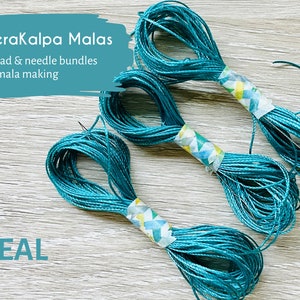 May include: Three spools of teal thread for mala making. Each spool is wrapped with colorful washi tape and includes a needle.