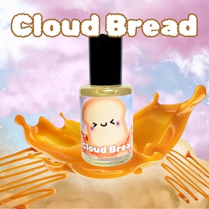 May include: A small glass bottle with a yellow label featuring a cartoon illustration of a slice of bread with a smiling face. The label reads "Cloud Bread". The bottle is surrounded by a splash of orange liquid.