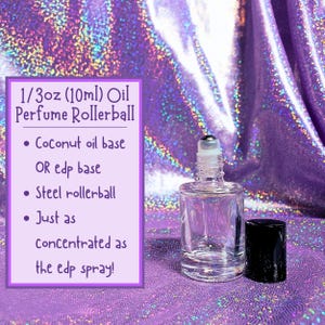May include: A clear glass rollerball bottle with a black lid and a silver rollerball. The bottle is filled with a clear liquid. The text on the white label reads "1/3oz (10ml) Oil Perfume Rollerball &bull; Coconut oil base OR edp base &bull; Steel rollerball &bull; Just as concentrated as the edp spray!"