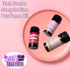 May include: Three 3 ml glass bottles of perfume oil on a pink plate. The bottles are labeled "Strawberry Milk! Perfume Oil", "Raspberry Milk! Perfume Oil", and "Peach Milk! Perfume Oil".