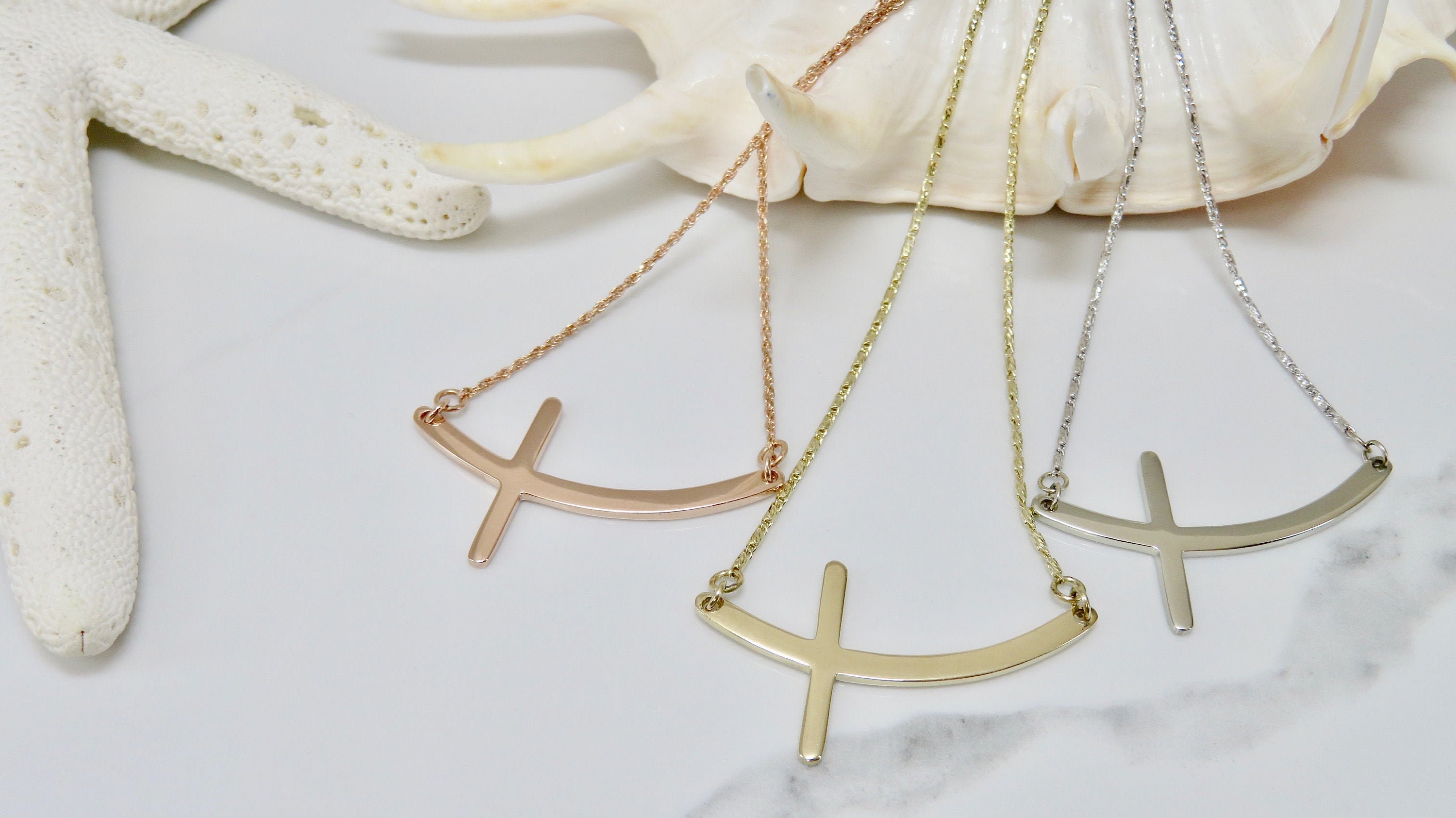 Curved sideways 2024 cross necklace