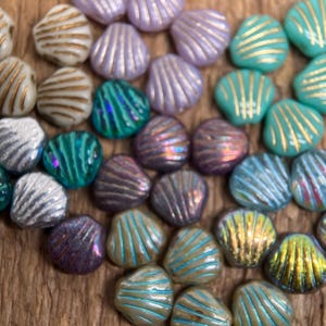 May include: A set of three ceramic mugs with a speckled, matte finish. Each mug features a different color: light blue, cream, and gray. The mugs have a simple, modern design and a comfortable handle.