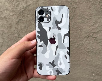 May include: A white and gray camouflage phone case for an iPhone.