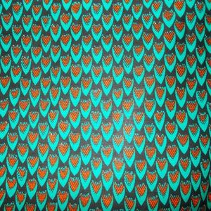 May include: A fabric with a repeating pattern of teal teardrop shapes, each containing a cluster of orange dots, set against a dark gray background. The design creates a textured, visually engaging surface.