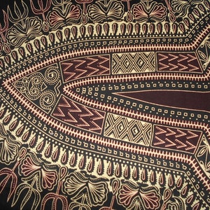 May include: A black fabric with a repeating pattern of geometric shapes and floral designs in gold and burgundy.