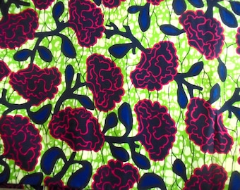 May include: A green and white fabric with a repeating pattern of pink and black flowers. The flowers have a dark blue outline.