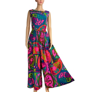 May include: A sleeveless jumpsuit with a psychedelic print in shades of pink, green, blue, and orange. The jumpsuit has a wide leg and a fitted bodice.