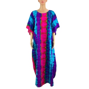 May include: A long, flowing tie-dye dress in shades of blue, pink, and purple. The dress features a round neckline and short, wide sleeves. The fabric has a vertical stripe pattern.