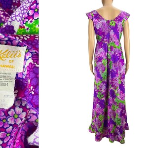 May include: A purple and green floral maxi dress with a scoop neck and cap sleeves. The dress has a label that reads "Kell's of Hawaii" and "RN 40554".