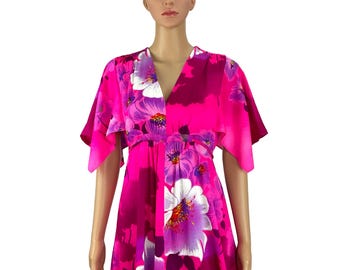 May include: A pink dress with a floral print featuring large purple and white flowers. The dress has a V-neckline and short, wide sleeves.