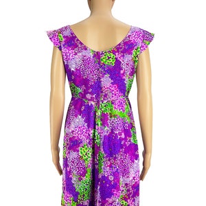 May include: A purple and green floral print dress with short sleeves and a scoop neck.
