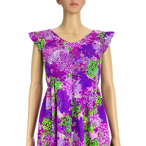 May include: A purple and green floral print dress with a V-neck and short, ruffled sleeves.