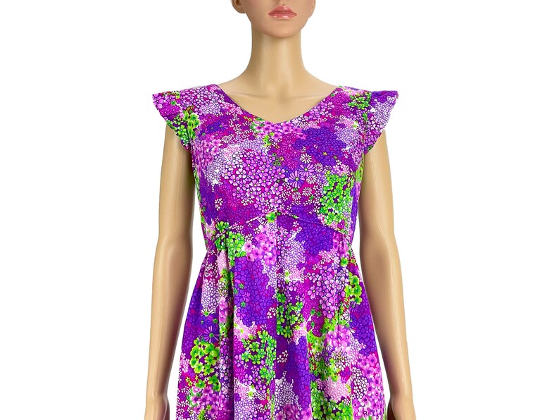 May include: A purple and green floral print dress with a V-neck and short, ruffled sleeves.
