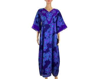 May include: A long, flowing purple dress with a floral print. The dress has a V-neck and 3/4 sleeves. The flowers are a light blue color with a darker blue outline.