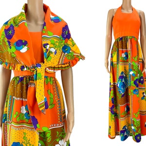 May include: A vintage orange maxi dress and matching shawl. The dress has a halter top and a patterned skirt with floral and geometric designs in orange, brown, yellow, and blue. The shawl has a frilled edge and a tie closure.