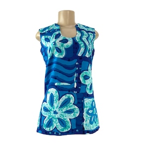 May include: A sleeveless blue and green dress with a floral pattern. The dress has a scoop neck and a loose fit.