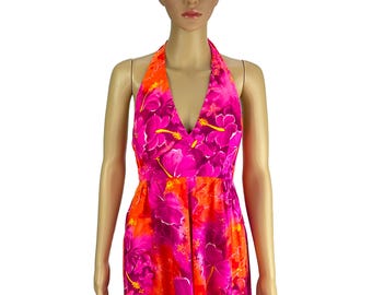 May include: A halter-neck dress in a vibrant floral print featuring shades of pink, orange, and yellow. The dress has a V-neckline and a fitted bodice, with a flowing skirt. The floral pattern includes hibiscus flowers.