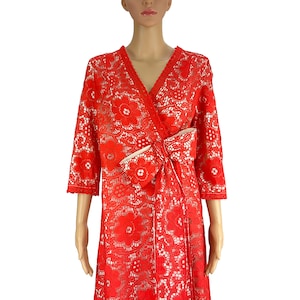 May include: A red lace wrap dress with a white lace bow at the waist.