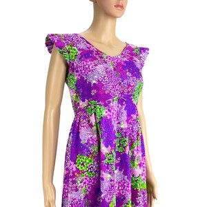 May include: A purple and green floral print dress with a V-neck and short ruffle sleeves.