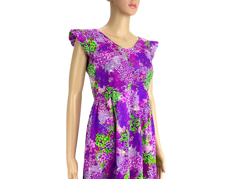 May include: A purple and green floral print dress with a V-neck and short ruffle sleeves.