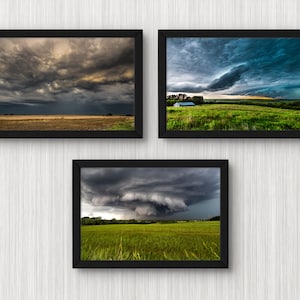 May include: Three framed photographs of stormy skies over a grassy field. The top left photo shows a dark, stormy sky with a hint of sunlight breaking through the clouds. The top right photo shows a dark, stormy sky with a single house in the distance. The bottom photo shows a dark, stormy sky with a funnel cloud forming in the distance.