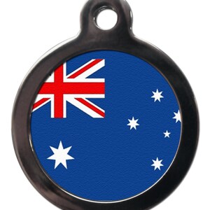 May include: A round silver pet tag with a blue background and a white star in the lower left corner. The top left corner features a red, white, and blue Union Jack flag. There are six white stars on the blue background.
