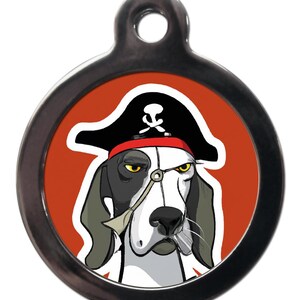 May include: A round, silver dog tag featuring a cartoon image of a dog wearing a pirate hat and an eyepatch. The dog has black and white fur and a red bandana. The background is orange.
