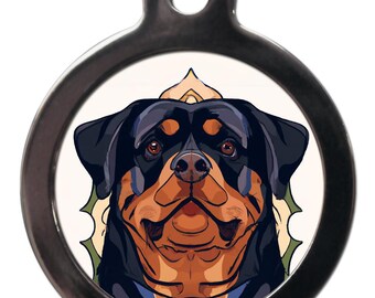 May include: A round, silver dog tag with a cartoon image of a Rottweiler dog. The dog has black fur, a brown face, and a white chest. The dog is looking directly at the viewer.