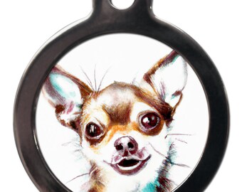May include: A round silver dog tag with a watercolor illustration of a brown and white chihuahua looking at the camera with a happy expression.