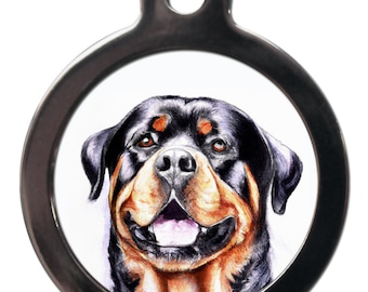 May include: A round, silver dog tag with a black and tan Rottweiler dog's head on it. The dog is looking directly at the camera with its mouth slightly open.