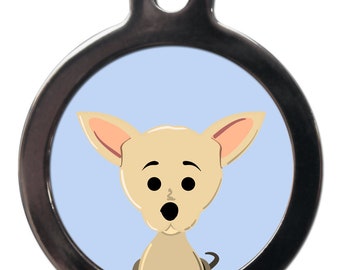 May include: A round, silver dog tag with a light blue background and a cartoon image of a tan chihuahua with big, surprised eyes.