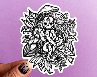 May include: Black and white sticker featuring a skull with a triangle on its forehead, surrounded by a snake and various floral and mushroom designs.