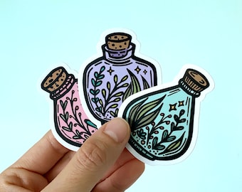May include: Three sticker designs of glass bottles with cork stoppers and various colored liquids. Each bottle contains a different arrangement of green, yellow, and purple leaves and flowers.