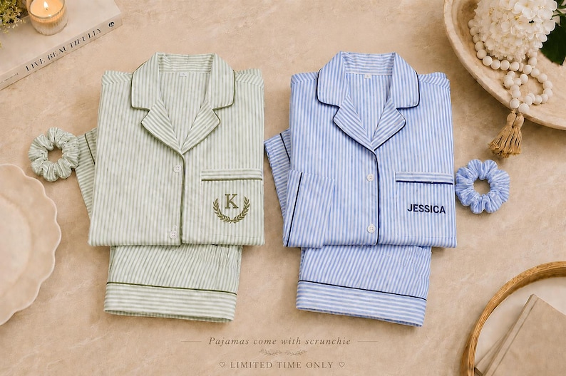 May include: Two sets of button-down pajamas with matching scrunchies. One set is light green with white stripes and a gold embroidered letter K in a wreath. The other is light blue with white stripes and the name JESSICA embroidered in navy blue.